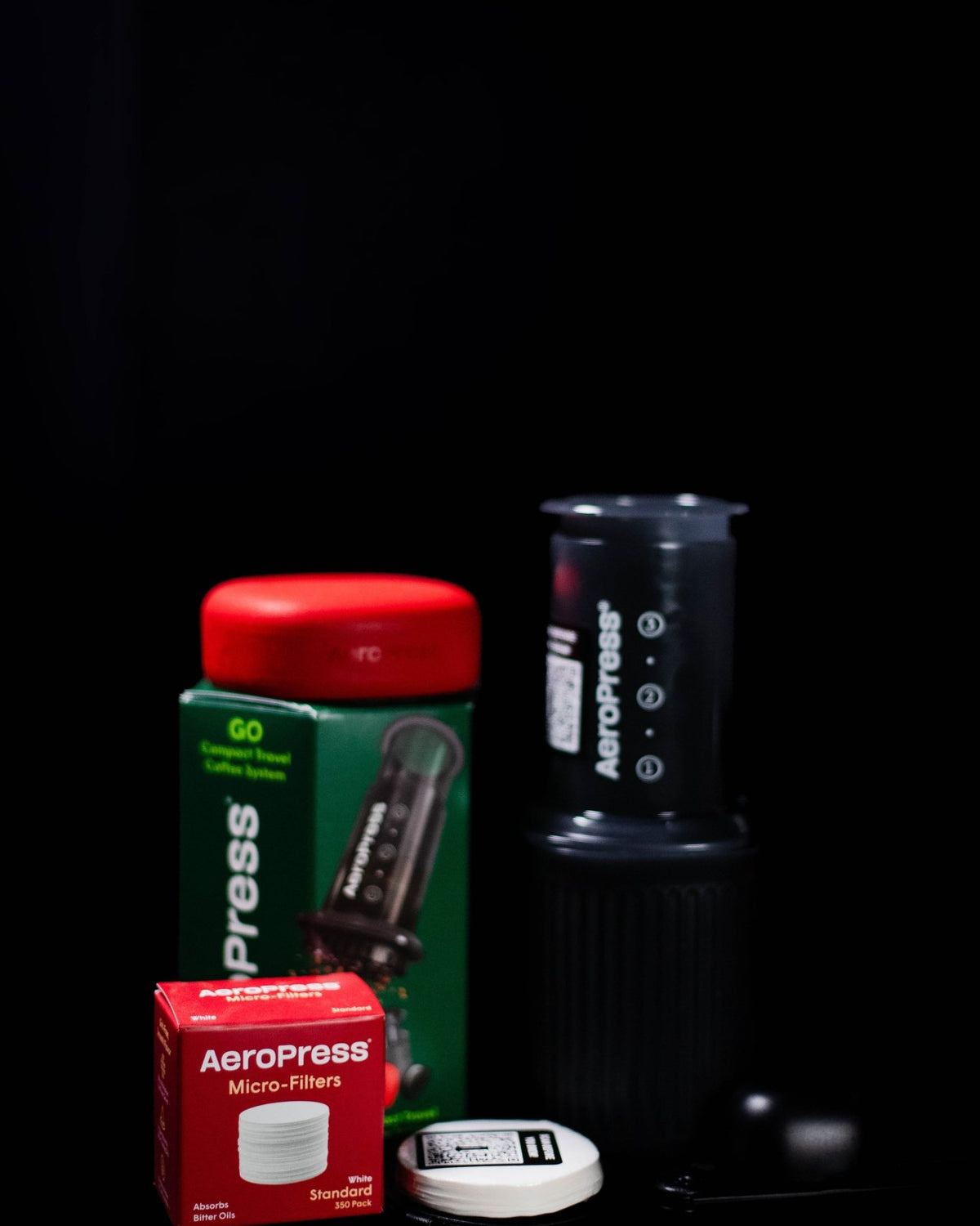 AeroPress Go travel coffee maker with compact drinking mug and silicone lid